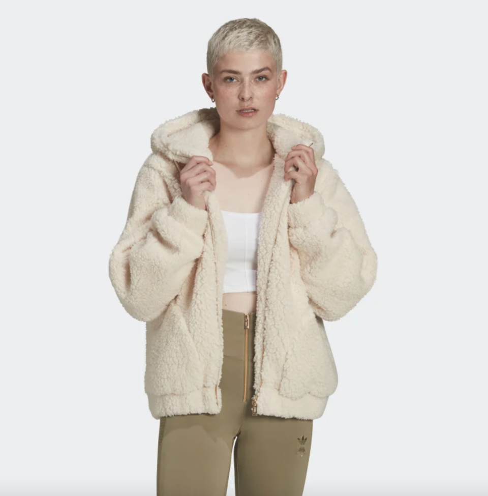 woman with short blonde hair in light cream Sherpa Jacket (Photo via Adidas)