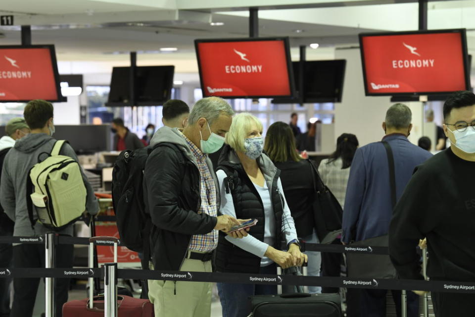 Passengers lining up to check in for Qantas flight QF143, an Airbus A330, the first one for the airline to New Zealand as it travels out of Sydney's International Airport en route from Australia to New Zealand.