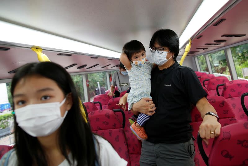 The Wider Image: Leaving Hong Kong: A family makes a wrenching decision