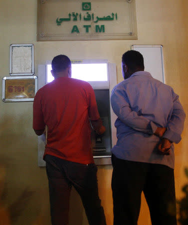 Customers use an automated teller machine (ATM) in Khartoum, Sudan November 8, 2018. Picture taken November 8, 2018. REUTERS/Mohamed Nureldin Abdallah