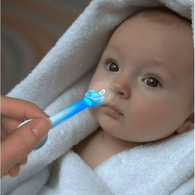 model using blue nose cleaner to clean baby's nose