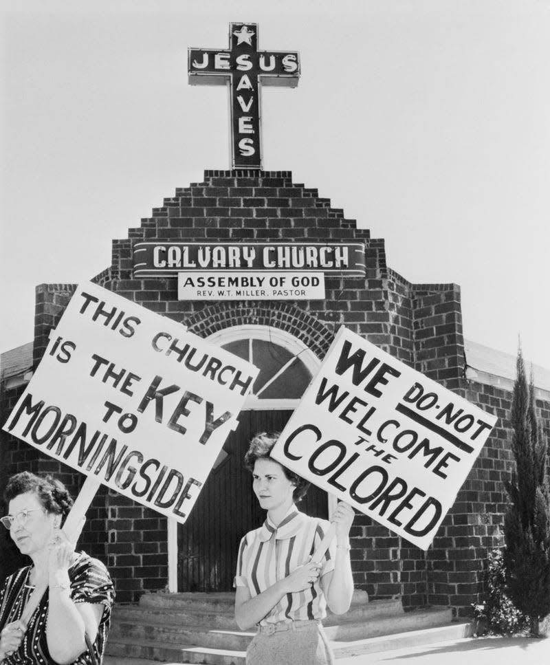 Original Caption) October 9, 1956 - Fort Worth, Texas: Mrs. E.T. Holden and Mrs. Peggy Richard picket the Calvary Assembly of God church. After the Pastor, Reverend W.T. Miller, sold the building to a Negro congregation. The church is located in the racially tense Morningside addition. White residents expressed fears that Negro families would move into the area. - Photo: Bettmann / Contributor (Getty Images)