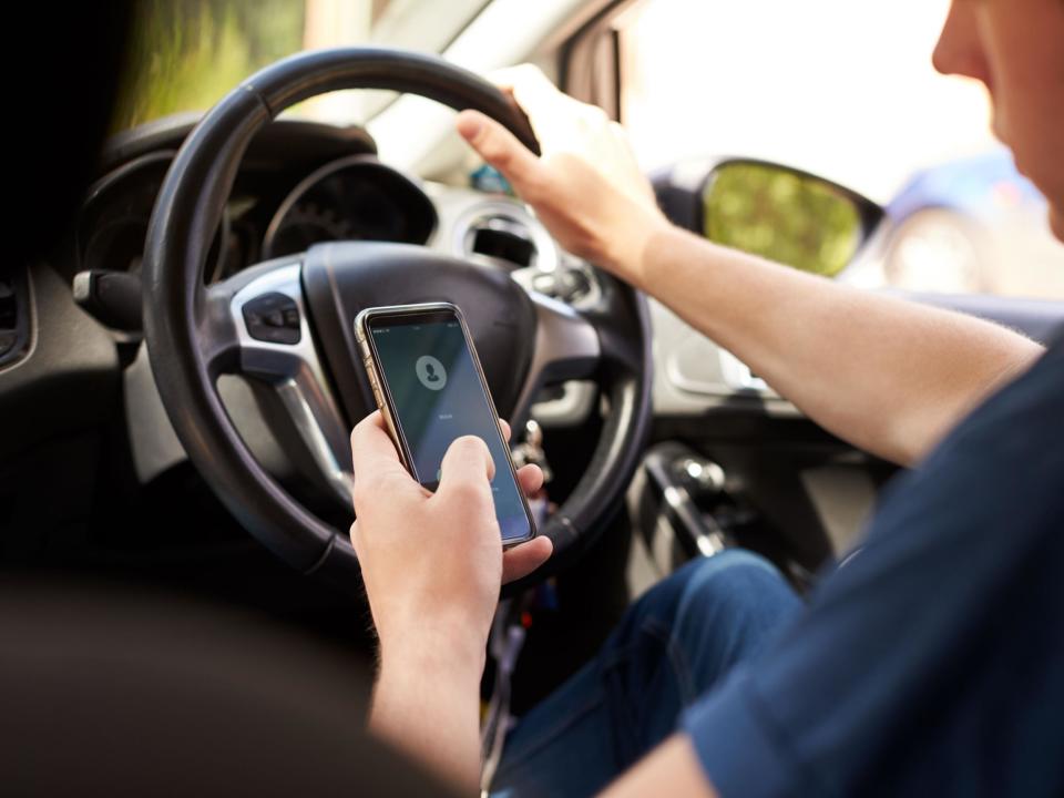 Nearly a third of drivers confessed to checking their mobile phone when behind the wheel: Rex Features