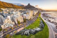Artist Saype spray paints iconic "Beyond Walls" frescoes in Cape Town