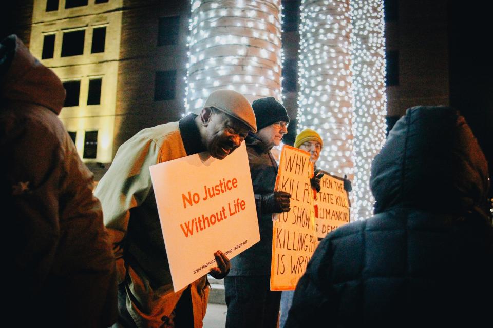 Demonstrators protest the execution of Kevin Johnson on Tuesday, Nov. 29, 2022 in downtown Columbia, Mo.