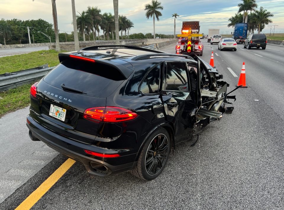 A Porsche with heavy damage to its front right side is parked on I-75 in Weston Tuesday, Jan. 2, 2024.