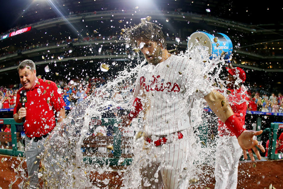 Bryce Harper #3 of the Philadelphia Phillies is doused with water by teammate Jean Segura #2 after hitting a walk-off two run double in the ninth inning to defeat the Los Angeles Dodgers 9-8 in a baseball game at Citizens Bank Park on July 16, 2019 in Philadelphia, Pennsylvania. (Photo by Rich Schultz/Getty Images)