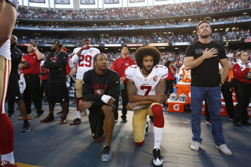 Eric Reid, left and Colin Kaepernick of the San Francisco 49ers kneel on the sideline during the national anthem as free agent and former Green Beret Nate Boyer stands before a game against the San Diego Chargers in 2016.