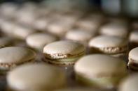 A worker prepares a macaron at the workshop of Belgian chocolate maker Marcolini, in Brussels