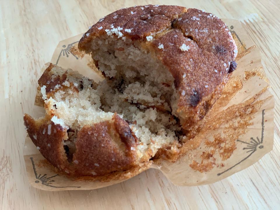 trader joe's coffee cake muffin pulled apart on wood counter