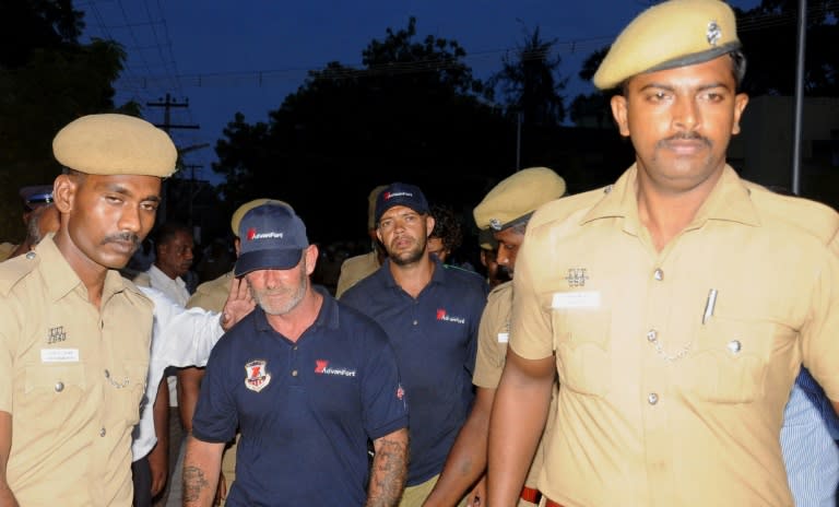 Indian police escort foreign sailors after their 2013 detention in Tuticorin