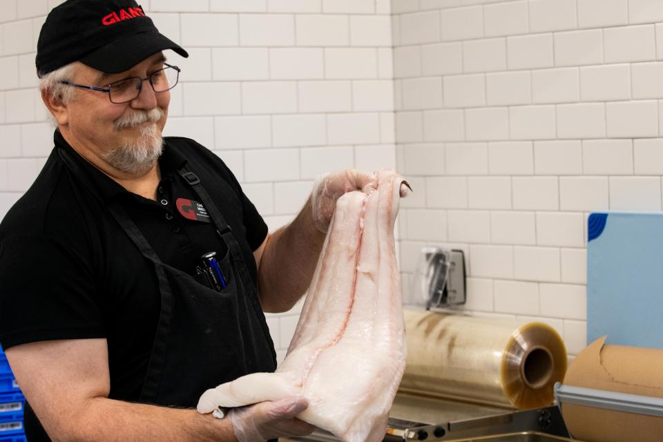 Chet Mikos holds a piece of Halibut behind the seafood bar at Richboro’s new GIANT. The store, located at 1025 2nd St. Pike, offers more spacious aisles and new features, including a new Beer and Wine section, a specialty cheese section and an artisan bread case with self-serve loaf slicing.