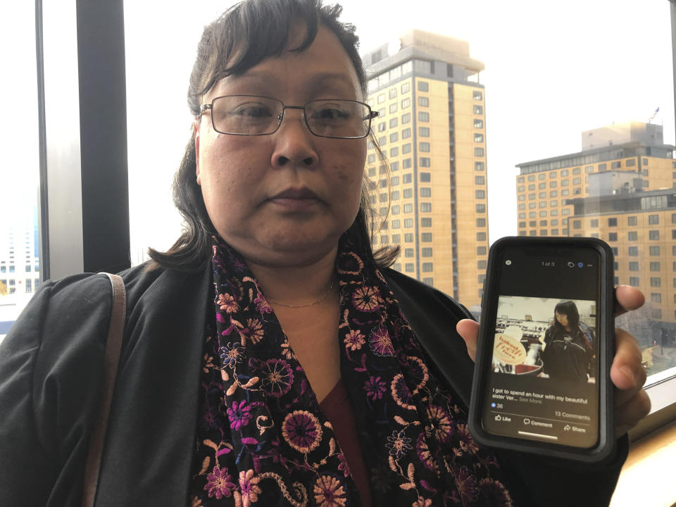 Rena Sapp, outside a courtroom Monday, Oct. 21, 2019, in Anchorage, Alaska, shows a photo of her sister, Veronica Abouchuk, taken during a day out shopping in 2013. Sapp attended the arraignment of Brian Steven Smith, who is accused of killing Abouchuk. (AP Photo/Mark Thiessen)