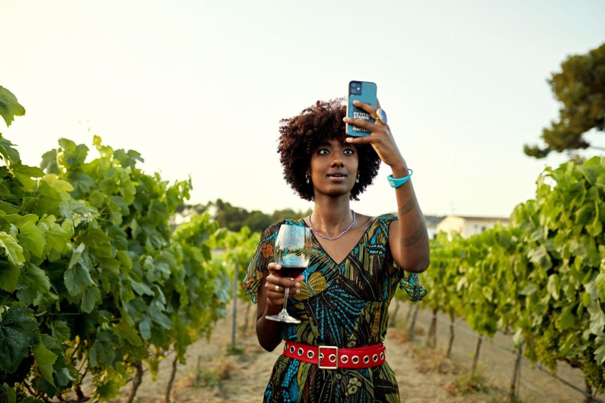 woman taking a selfie in a vineyard