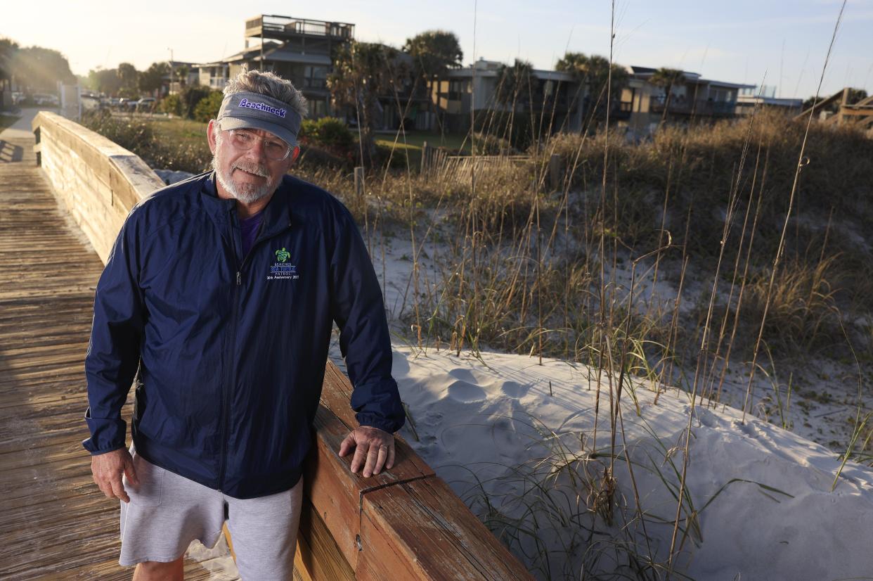 Retired Fletcher High football coach and teacher Kevin Brown stands on a walkover that crosses what he calls "Rowan's dune," a dune rebuilt by former student Rowan Lee. Brown, who taught marine and environmental science at Fletcher, has been named 2024 “Friend of the Beaches” by Beaches Watch.