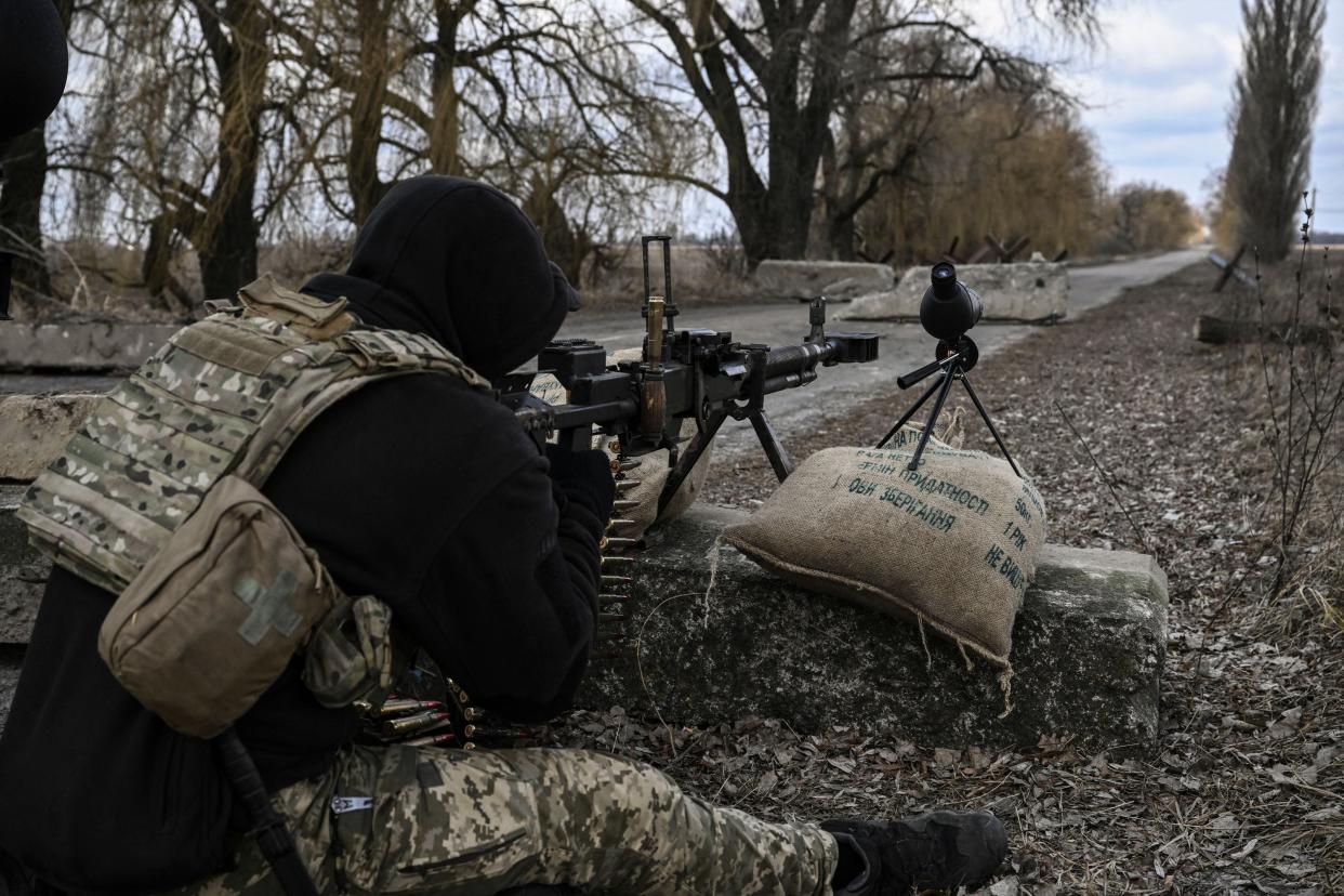 A Ukrainian serviceman aims towards Russian positions outside the city of Brovary, east of Kyiv, on March 9, 2022.