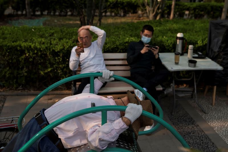An elderly man exercises in a park in Beijing