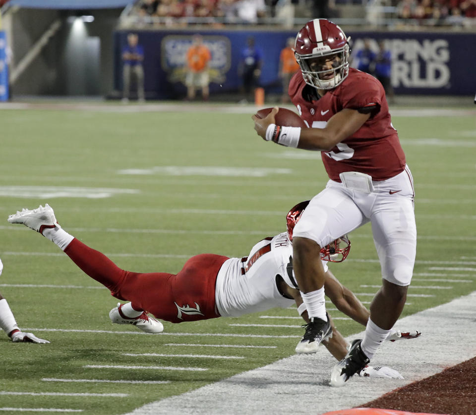 Alabama quarterback Tua Tagovailoa, right, is forced out of bounds by Louisville safety Dee Smith after a short gain during the first half of an NCAA college football game Saturday, Sept. 1, 2018, in Orlando, Fla. (AP Photo/John Raoux)