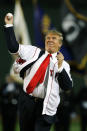 Donald Trump throws out the ceremonial first pitch before the start of the game between the Boston Red Sox and the New York Yankees in the second game of a day/night doubleheader Friday, Aug.18, 2006, at Fenway Park in Boston. (AP Photo/Charles Krupa)