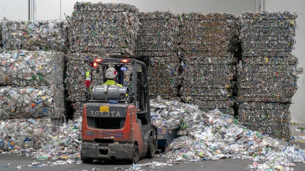 PHOTO: In this June 22, 2022, file photo, an employee operates a forklift to move bales of plastic bottles at the rPlanet Earth plastics recycling plant in Vernon, Calif. (Bloomberg via Getty Images, FILE)