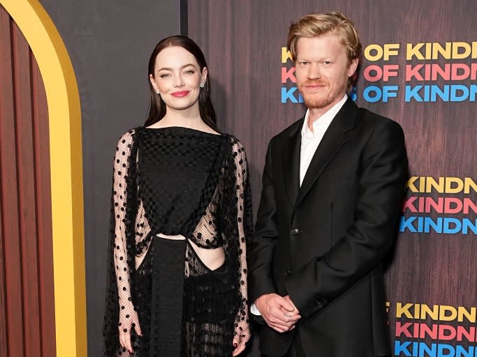 Emma Stone in a sheer dotted gown and Jesse Plemons in a dark suit on the red carpet