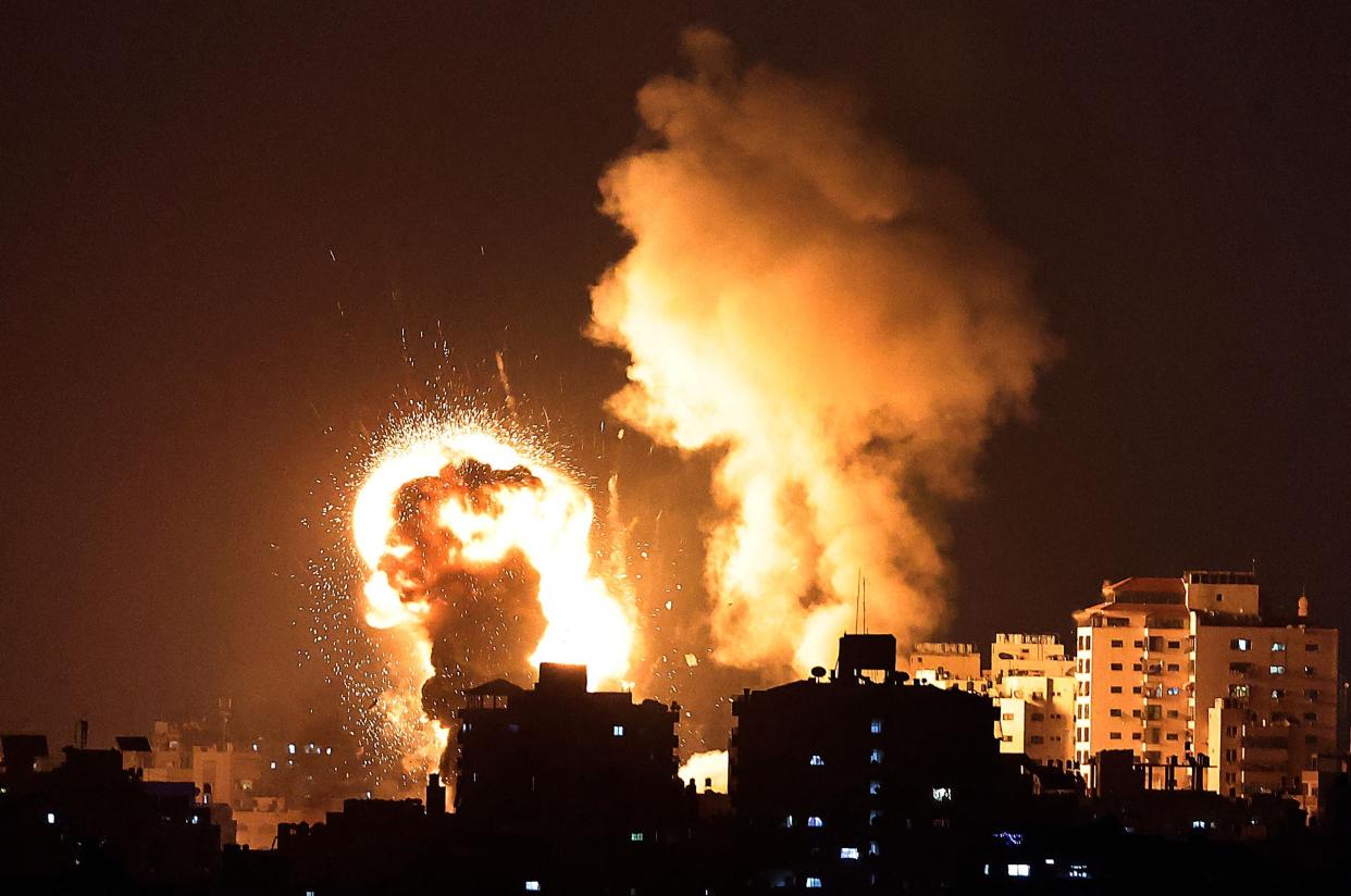 <p>Fire billows from Israeli air strikes in the Gaza Strip</p> (AFP/Getty)