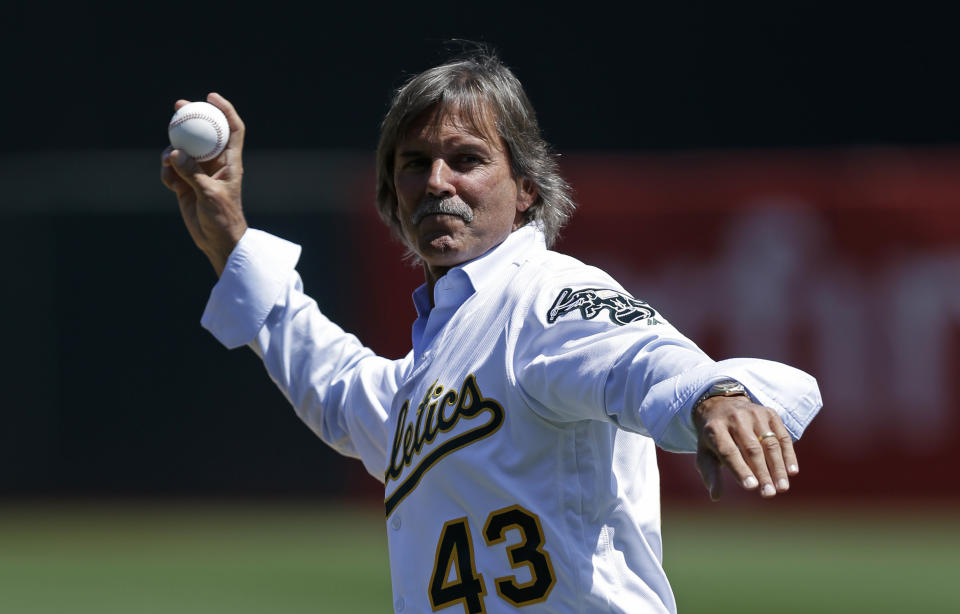 Former Oakland Athletics pitcher and MLB Hall of Famer Dennis Eckersley throws the ceremonial first pitch on his bobblehead day. (AP)