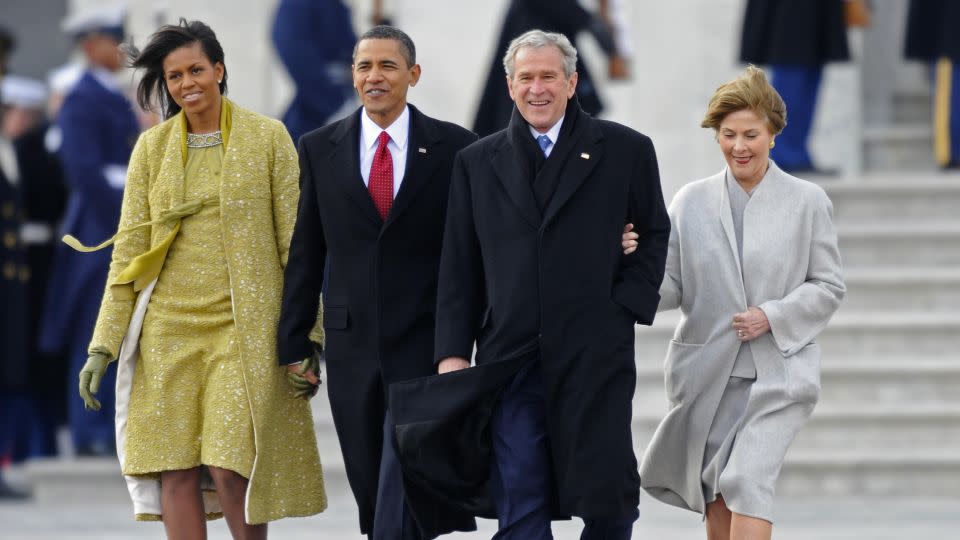 Former US President George W. Bush and his wife Laura are escorted to a waiting helicopter by President Barack Obama and his wife Michelle as the Bushes depart from the US Capitol after the swearing in of Obama as the 44th President of the United States. - Tannen Maury/AFP/Getty Images