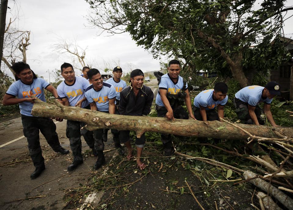 <p>Filipino policemen clear a fallen tree in the typhoon-hit town of Caranglan, Cagayan province, Philippines, on Sept. 15, 2018 (issued Sept. 16, 2018).<br>Mangkhut, the most powerful typhoon to hit the Philippines in the last five years, has weakened slightly after its passage through the northern part of the country, with sustained winds of 170 kilometers per hour and gusts of up to 260 kilometers per hour without any reports of casualties so far, authorities said. Over 50,000 people in all regions expected to be struck by the typhoon have been evacuated although over 5.2 million Filipinos living in a 125 kilometer radius from Mangkhut’s trajectory will feel its impact, according to the National Disaster Risk Reduction and Management Council.<br>(Photo by Francis R. Malasig, EPA) </p>