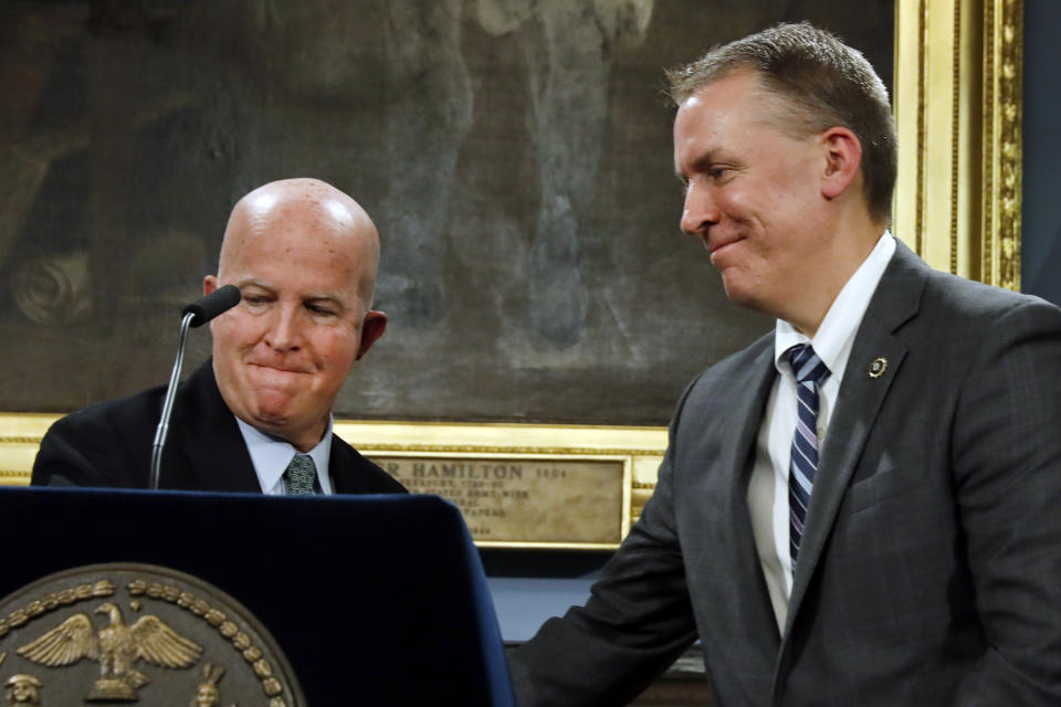 New York City Police Commissioner James O'Neill, left, shakes hands with his successor, Chief of Detectives Dermot Shea, at New York's City Hall, Monday, Nov. 4, 2019. New York City's police commissioner is retiring after three years in charge of the nation's largest police department, Mayor Bill de Blasio said Monday. (AP Photo/Richard Drew)