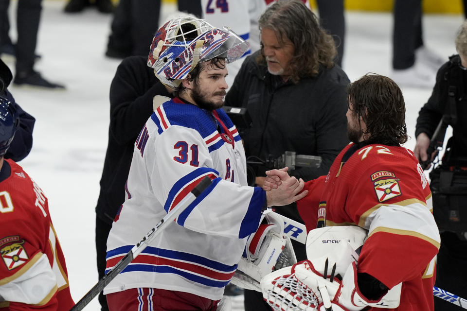 New York Rangers goaltender Igor Shesterkin (31) shakes hands with Florida Panthers goaltender Sergei Bobrovsky, right, after the Panthers won Game 6 to win the Eastern Conference finals of the NHL hockey Stanley Cup playoffs Saturday, June 1, 2024, in Sunrise, Fla. (AP Photo/Lynne Sladky)