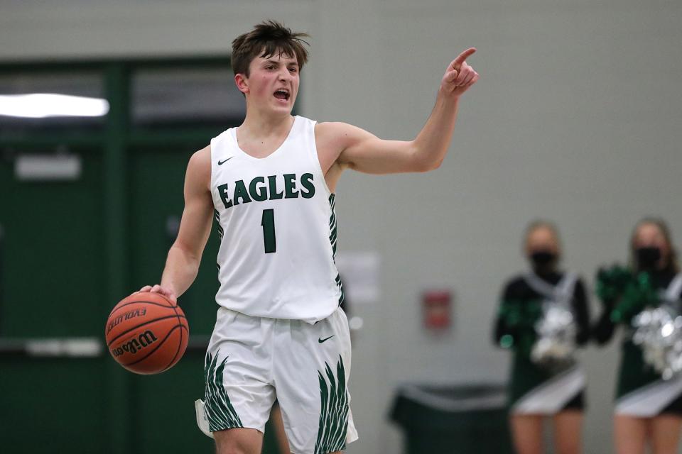 Zionsville Eagles' Dylan Ritter (1) shouts to teammates during the first half of the game Friday, Jan. 22, 2021, at Zionsville High School. 