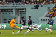 Cody Gakpo of the Netherlands, left, scores the opening goal during the World Cup group A soccer match between Netherlands and Ecuador, at the Khalifa International Stadium in Doha, Qatar, Friday, Nov. 25, 2022. (AP Photo/Natacha Pisarenko)