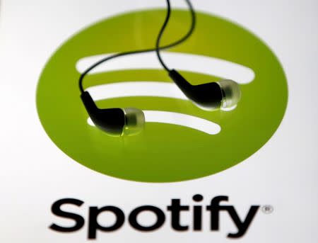 Earphones are seen on a tablet screen with a Spotify logo on it, in Zenica, Bosnia and Herzegovina, February 20, 2014. REUTERS/Dado Ruvic/File Photo