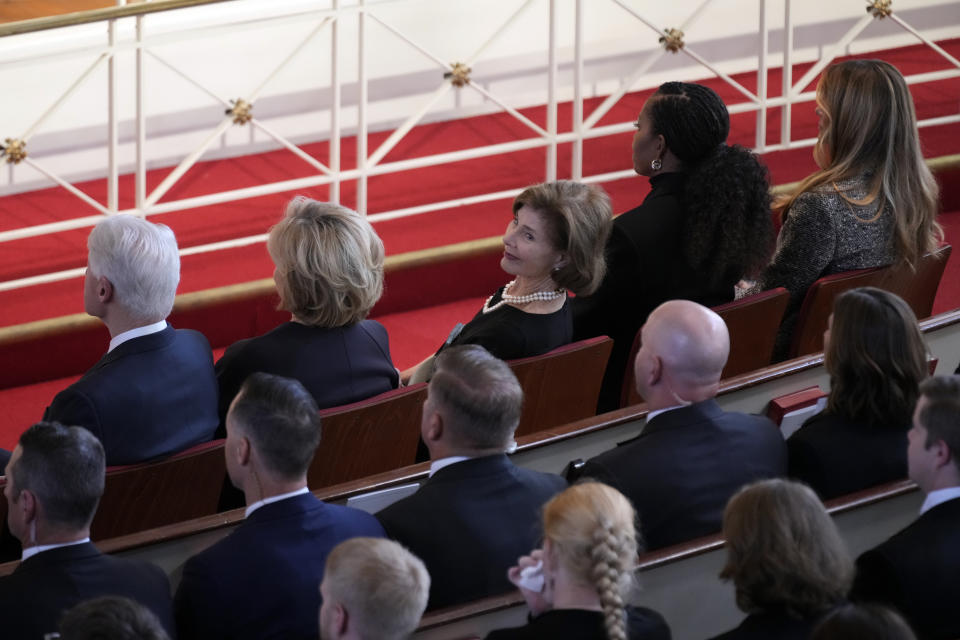 Former first lady Laura Bush glances back during a tribute service for former first lady Rosalynn Carter, at Glenn Memorial Church, in Atlanta, Tuesday, Nov. 28, 2023, as she sits with, from left, former President Bill Clinton, former Secretary of State Hillary Clinton, former first lady Michelle Obama and former first lady Melania Trump. (AP Photo/Andrew Harnik)