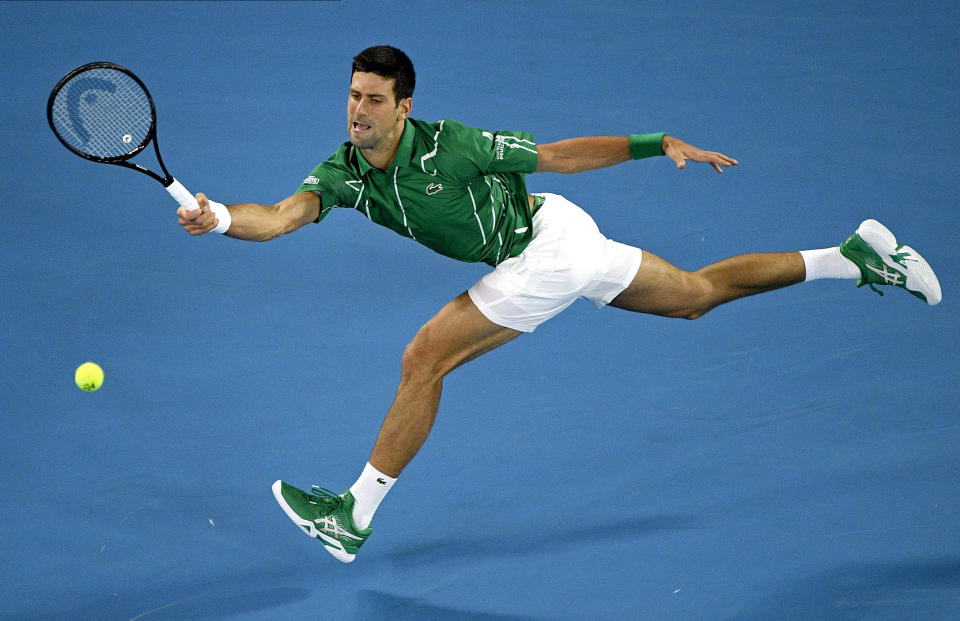 FILE - In this Monday, Jan. 20, 2020, file photo, Serbia's Novak Djokovic makes a forehand return to Germany's Jan-Lennard Struff during their first round singles match the Australian Open tennis championship in Melbourne, Australia. Djokovic is scheduled to play in the U.S. Open, scheduled for Aug. 31-Sept. 13, 2020. (AP Photo/Andy Brownbill, File)