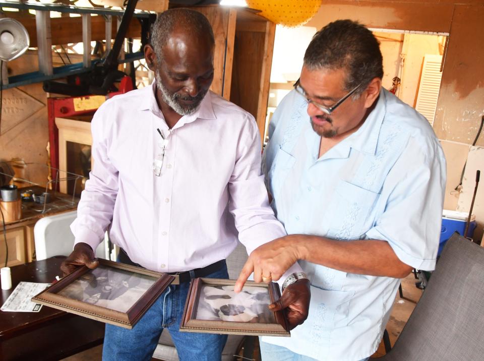 Crosley Green shows John A. Torres family photos during an exclusive one-on-one interview just days before he is to report back to prison.
(Photo: MALCOLM DENEMARK/FLORIDA TODAY)