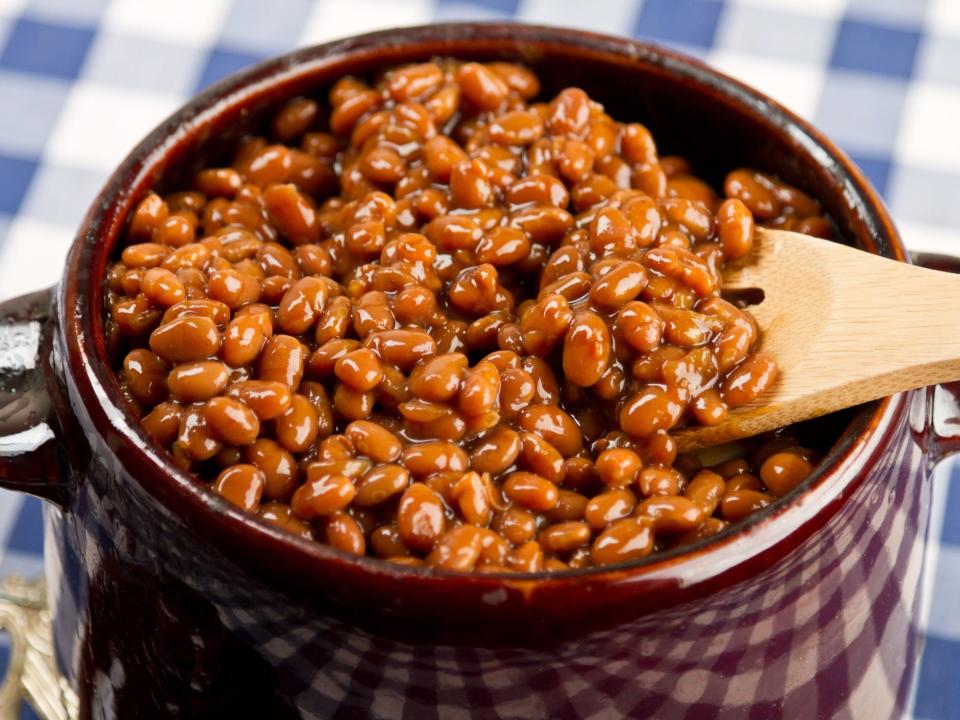 baked beans in a pot with wooden spoon