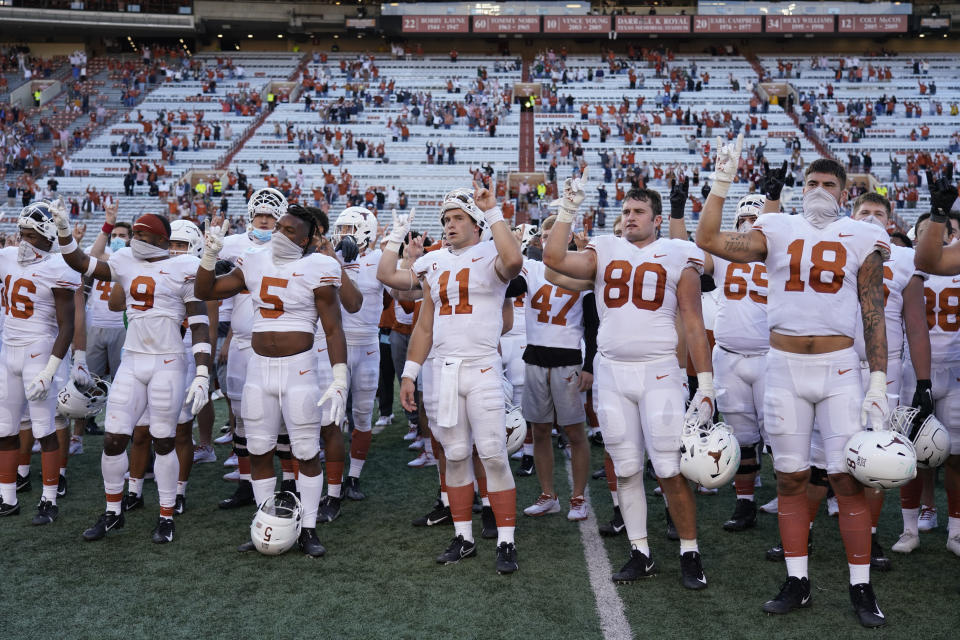 Texas players, including Sam Ehlinger (11), sing "The Eyes Of Texas" after an NCAA college football game against Baylor in Austin, Texas, Saturday, Oct. 24, 2020. (AP Photo/Chuck Burton)