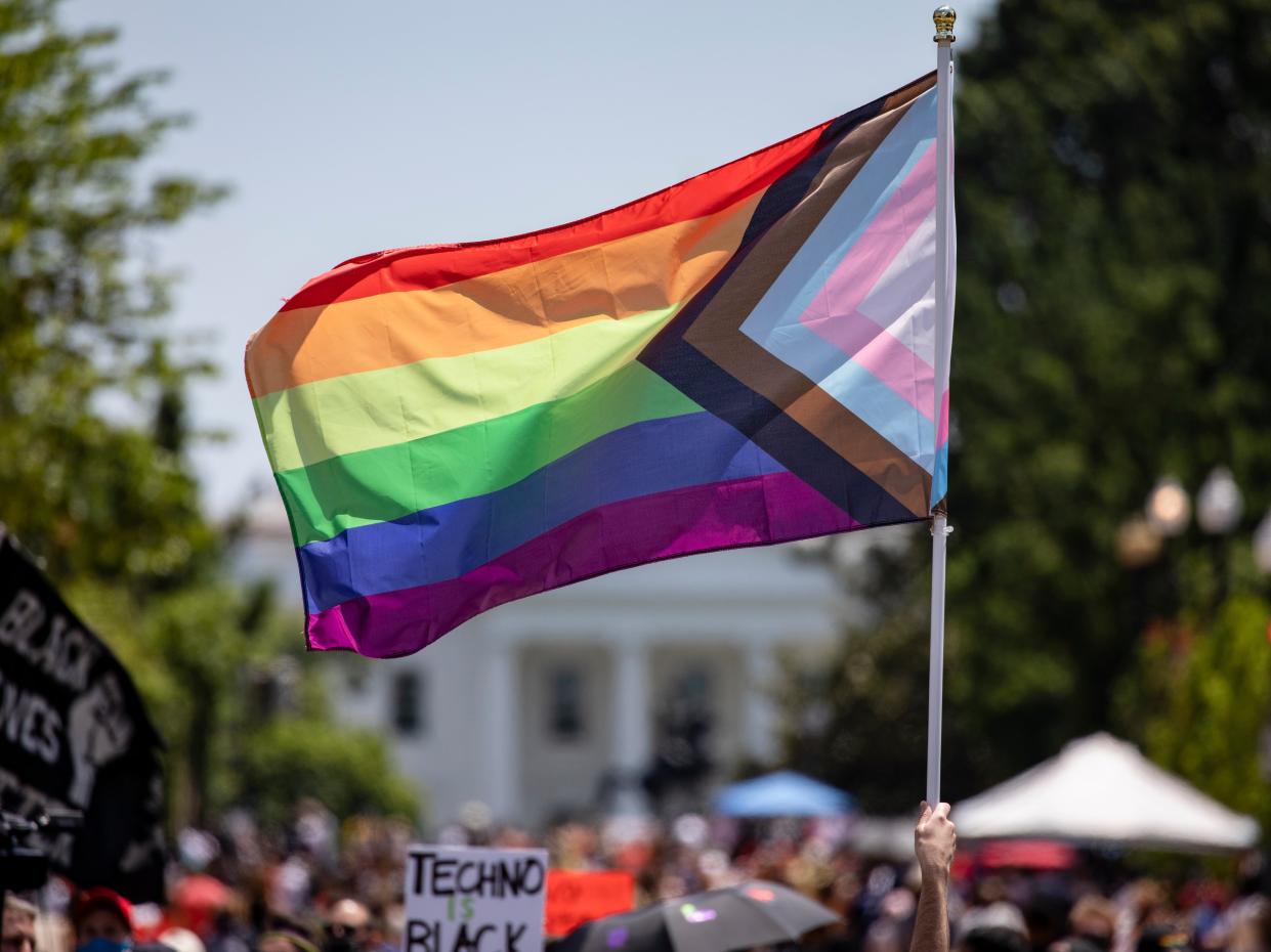 <p>Members and allies of the LGBT+ community reach Black Lives Matter Plaza across the street from the White House as part of the Pride and Black Lives Matter movements on 13 June, 2020 in Washington, DC</p> (Getty Images)