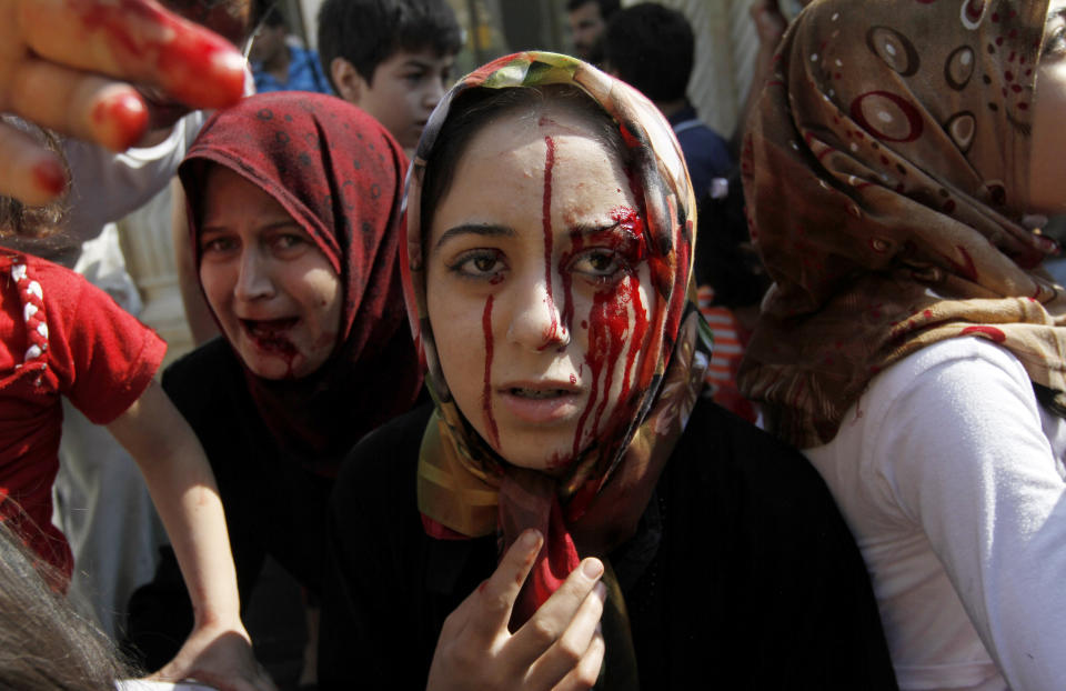 FILE - In this Wednesday, Aug. 15, 2012 file photo, injured Syrian women arrive at a field hospital after an air strike hit their homes in the town of Azaz, on the outskirts of Aleppo, Syria. Syrians are marking 10 years since peaceful protests against President Bashar Assad's government erupted in March 2011, touching off a popular uprising that quickly turned into a full-blown civil war. (AP Photo/Khalil Hamra, File)