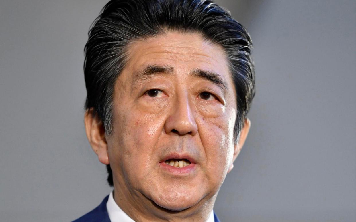 Mr Abe is accused of turning a flower-viewing party into an election campaign event - Kyodo News