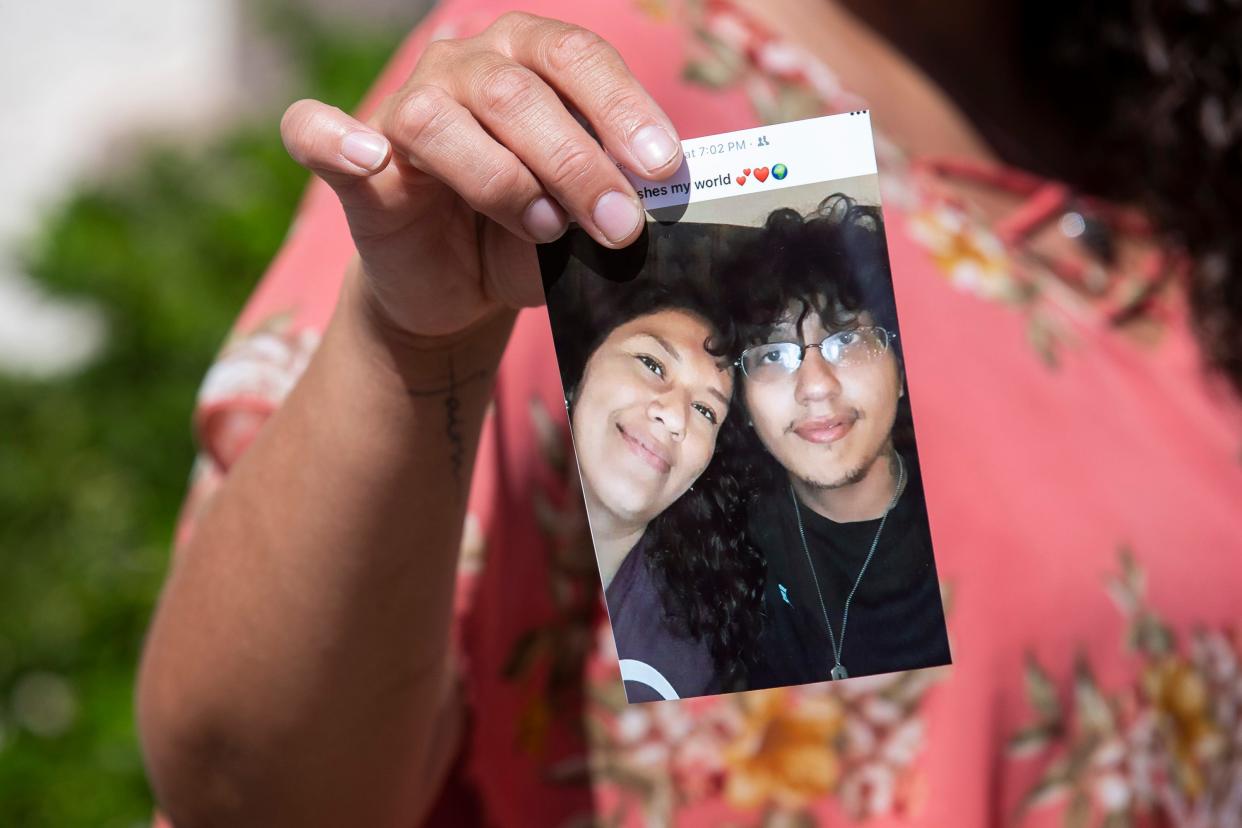 Ana Sandoval, mother of Angel Benitez, who was shot and killed by Mesa police, holds up a photo of Benitez during a press conference on Sept. 28, 2020, in Phoenix.