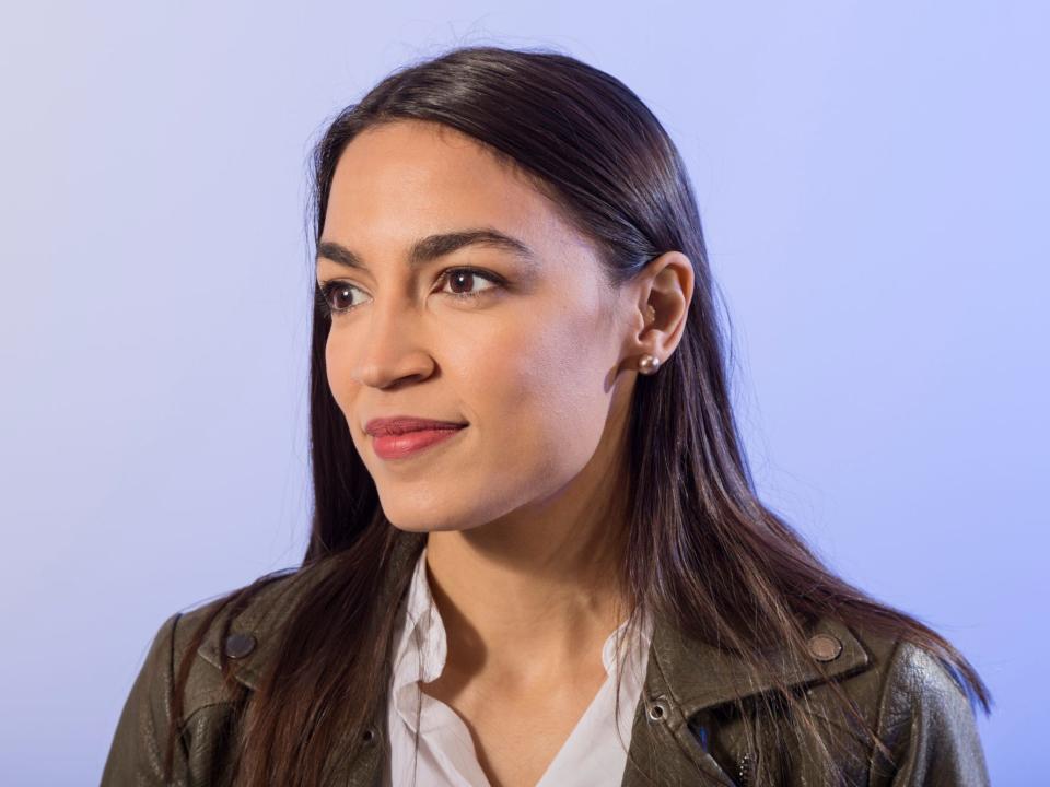 Alexandria Ocasio Cortez against a purple background