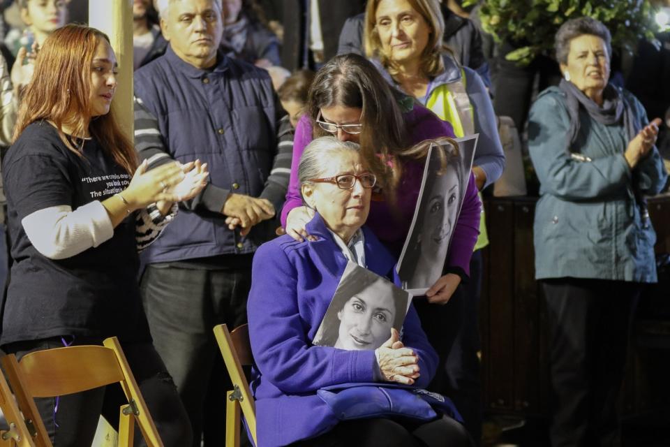 Rose Vella, mother of late Daphne Caruana, take part in a protest in La Valletta, Malta, Sunday, Dec. 1, 2019. Malta's embattled prime minister has received a pledge of confidence from Labor Party lawmakers amid demands for his resignation by citizens angry over alleged links of his former top aide to the car bomb killing of a Maltese anti-corruption journalist. Hours later, thousands of Maltese protested outside a courthouse demanding that Joseph Muscat step down. (AP Photo)