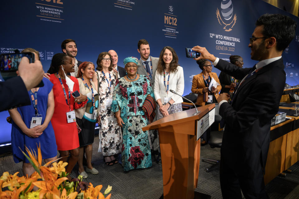 World Trade Organization Director-General Ngozi Okonjo-Iweala, center, poses for a picture after a closing session of a World Trade Organization Ministerial Conference at the WTO headquarters in Geneva early Friday, June 17, 2022. (Fabrice Coffrini/Pool Photo/Keystone via AP)