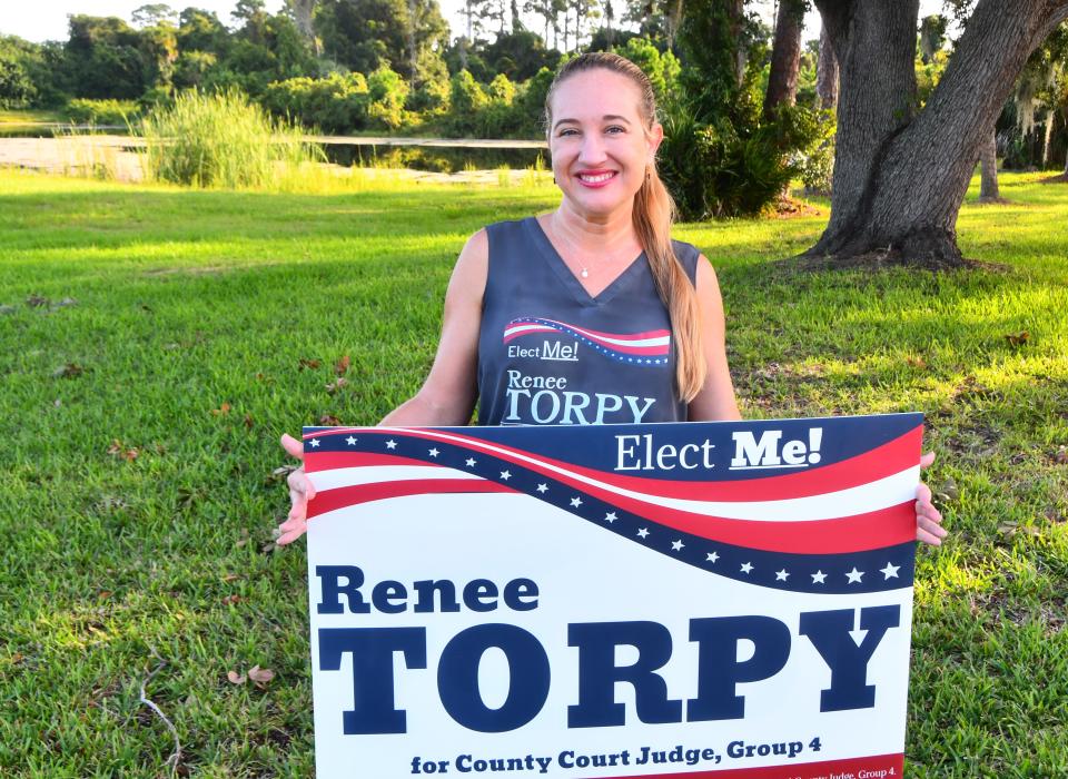 Brevard County Judge candidate Renee Torpy holds a sign on Election Day outside the Moose Lodge #2073 polling location on North Merritt Island.