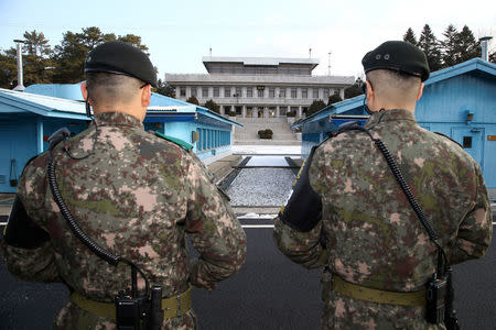 FILE PHOTO - South Korean soldiers stand guard at the truce village of Panmunjom in the demilitarised zone separating the two Koreas, South Korea, January 9, 2018. REUTERS/Korea Pool