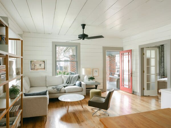 White-painted shiplap, added by a previous owner, gives the original living room a heritage feel. White oak flooring throughout the house fulfills Michelle's penchant for modernism and nods to the Scandinavian design in the inspiration images she sent architect Marisa Janusz.
