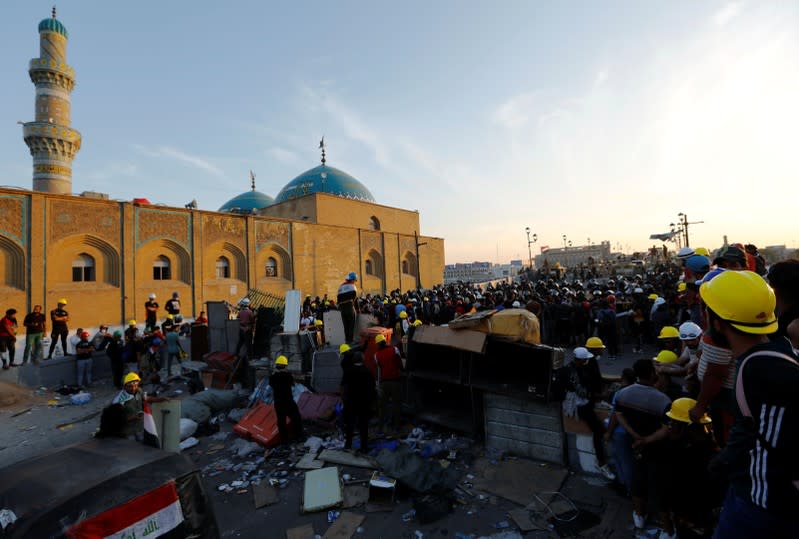 Demonstrators block Al Shuhada bridge during ongoing anti-government protests, in Baghdad